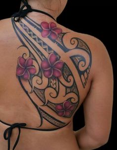 the back of a woman's tattoo with pink flowers on her shoulder and chest