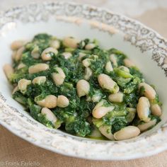 a close up of a bowl of food with broccoli and beans in it