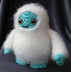 a white and blue stuffed animal sitting on top of a table