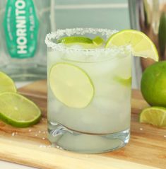 a margarita with limes and sugar on the rim