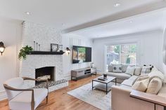 a living room filled with furniture and a fire place