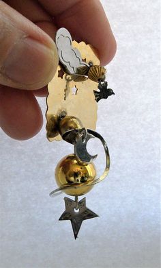 "A fantastic artsy Futuristic kinetic art pin with themes of Earth, Moon Galaxy in gold and silver metal. The gold ball is suspended on soldered wire with a silver ring and moon dangling around it. There is a cloud and bird with cut out stars. Very special and unique artisan pin. In great vintage condition. Measures 2 3/4\" long x 1 1/2\" wide x 3/4\" depth. Very Treky I will ship this item within one business day of receiving payment. Thank you. Enjoy For more Vintage Jewelry see my listings he Kinetic Jewelry, Moon Galaxy, Arm Bracelets Upper, Gold Galaxy, Coil Bracelet, Mixed Media Jewelry, Kinetic Art, Hand Painted Walls, Contemporary Modern Art