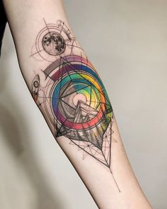 a person's arm with a colorful tattoo design on the left side of their arm