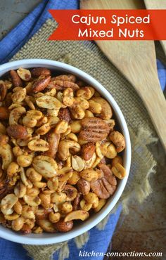 a white bowl filled with nuts on top of a blue towel