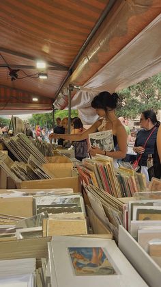 people are browsing books at an outdoor book sale