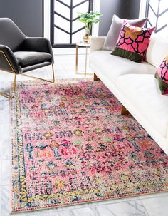 a living room with white couches and colorful rugs