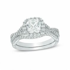 an engagement ring with a square cut diamond surrounded by pave and round brilliant diamonds