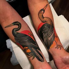 two people with matching tattoos on their legs, one has a knife and the other has a bird