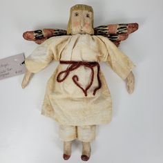 an old doll with wings and a heart on it