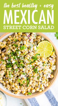 mexican street corn salad in a bowl with lime wedges and cilantro on the side