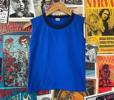 "Vintage kids 1980s blue two tone sleeveless ringer tank top shirt. Made of 100% cotton in the U.S.A. Is tagged a size medium, we estimate it to fit a kids 10, age 8/9, but please check measurements as this is an estimate. Has a small spot on back, but is in otherwise good, pre-owned condition. tag size | medium -- est. it to best fit kids size 10, age 8-9 *refer to measurements for sizing as this is an estimate measurements: chest -- 28\" total length -- 17\"" Retro Cotton Muscle Tee Sleeveless, Retro Sleeveless Muscle Tee In Cotton, Retro Cotton Sleeveless Muscle Tee, Retro Sleeveless Cotton T-shirt, Retro Blue Sleeveless Top, 90s Style Blue Sleeveless Tops, Vintage Blue Summer Vest, Vintage Blue Sleeveless Vest, Vintage Blue Sleeveless Top