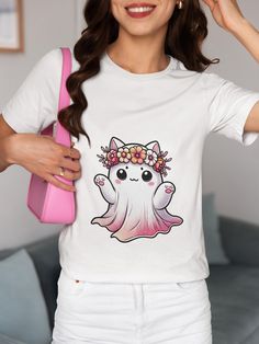 Celebrate your love for all things cute and spooky with this adorable kawaii ghost cat t-shirt featuring a whimsical flower crown. Perfect for Halloween or any time you want to add a touch of pastel goth to your wardrobe, this unisex graphic tee is a must-have for anime and cute cat lovers alike. We utilize the authentic Bella Canvas 3001 brand, renowned for its UNISEX design, making it one of the most sought-after shirts in the market. Prior to placing an order, kindly refer to our size chart. It can be located in both the listing's images and description. This cozy T-shirt serves as an ideal present, suitable for occasions such as birthdays, Christmas, or any special event for your closest friends, family members, or anyone dear to you. It's a wonderful gesture that's sure to bring a smi White Kawaii T-shirt With Cat Print, White Cat Print T-shirt For Halloween, Kawaii Halloween Short Sleeve T-shirt, Kawaii Short Sleeve Halloween T-shirt, Cute Spring T-shirt With Cat Design, Halloween White T-shirt With Cat Print, Cute White Tops For Halloween, Cute Halloween Cartoon Print T-shirt, Pastel Goth Anime