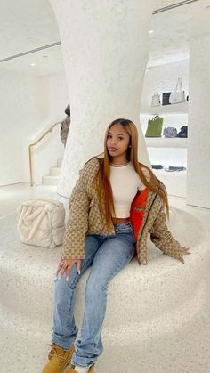 a woman sitting on top of a white object