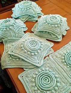 crocheted placemats and coasters on a table