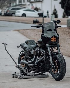 a black motorcycle is parked on the sidewalk