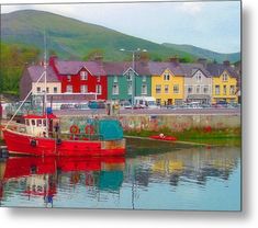 a red boat sitting in the middle of a body of water next to some houses