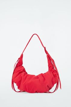 Named for its artfully ruched shape, the Canopy bag has drawstring ties at either side that pull in to create its signature gathered silhouette. It's made from padded nylon and has an ample zipped compartment. Zip closureRecycled nylon reduces our demand on limited natural resources and reduces greenhouse gas emissions   Shell: 73% Recycled polyamide (Recycled nylon), 27% Cotton. Lining: 50% Cotton, 50% Recycled cotton. Padding: 100% Recycled polyester. Excluding trims Height: 13.77", Width: 33. Cos Bags, Mens Straw Hats, Cutout Skirt, Padded Bag, Jodhpur Boots, Object Design, Glam Chic, Mens Holiday, Wool Mini Skirt