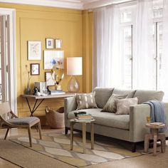 a living room filled with furniture and yellow walls