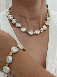 This exquisite coin pearl and gold beaded necklace and bracelet set showcases a stunning luster, enhanced by delicate pink and blue overtones. The harmonious blend of natural pearls and gold beads creates an elegant accessory that elevates any outfit, making it perfect for both casual and formal occasions.  Pearl size: 14mm Necklace length: 42cm Bracelet length: 20cm Beaded Necklace And Bracelet, Coin Pearl Necklace, Gold Beaded Necklace, Pearl Beaded Necklace, Special Gifts For Her, Gold Bead Necklace, Coin Pearls, Necklace And Bracelet, Outfit Making