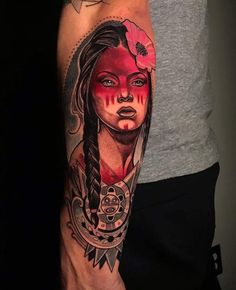 a woman's face with red paint on her body and head is shown in this tattoo