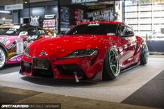 two red sports cars parked next to each other