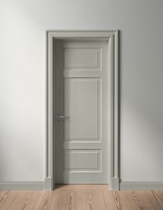 an open door in a white room with wood flooring and gray walls is shown