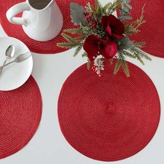 red placemats with flowers and silverware on them