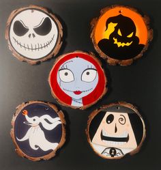 four painted wooden slices with jack and sally faces on them, all in different colors