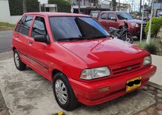 a red car is parked on the street