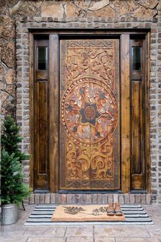 an ornate wooden door in front of a stone building