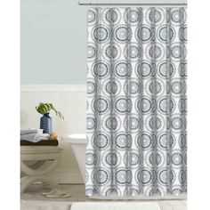 a shower curtain with blue and white circles on it in a bathroom next to a toilet