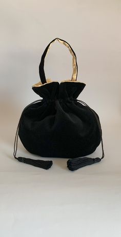 This elegant black velvet pouch bag is perfect as an evening bag and could also be used as casual bag  in both formal and informal occasions.  Dimensions:    Width 27 cm x Height 27cm  ( inside length when closed approx 20cm ).  Strap length approx: 38 cm including clasps The  black velvet fabric of this bag is lightweight and super soft. The lining is a medium weight buttermilk coloured satin, silky soft, the handmade drawstrings and  tassels are a soft black cotton decorated with black acrylic Credit Card Pouch, Embroidered Clutch Bag, Japanese Knot Bag, Black Velvet Fabric, Black Evening Bag, Vintage Evening Bags, Embroidered Clutch, Card Pouch, Bag Aesthetic