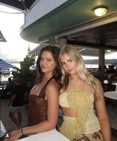 two beautiful young women standing next to each other