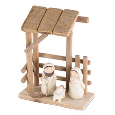 a nativity scene with two figurines in front of a small wooden structure