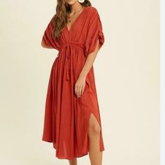 Wherever You Wear The Truly Perfect Brick Red Midi Dress You'll Have A Flawless Day! Lightweight Woven Fabric, In A Brick Red Hue, Shapes This Dress That Has A V-Neckline, A Blousy Bodice, And Puffy Dolman Sleeves With Elastic At The Cuffs. A Drawstring Tassel Tie At The Elastic Waist Tops An A-Line Midi Skirt.