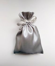 a silver satin bag on a white background