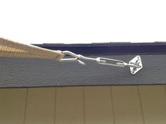 a close up of a metal chain attached to the side of a window sill