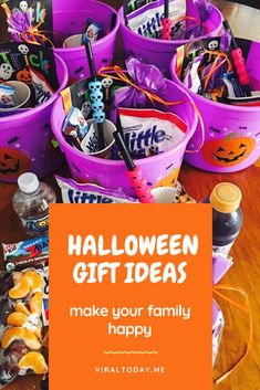 purple buckets filled with halloween gifts on top of a wooden table next to an orange sign that says make your family happy