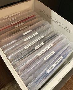 the drawer is full of clear files and labeled with labels for each file, which contains several different types of folders