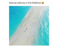 an aerial view of a beach with people walking on it