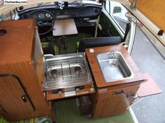 the inside of an rv with a sink and stove