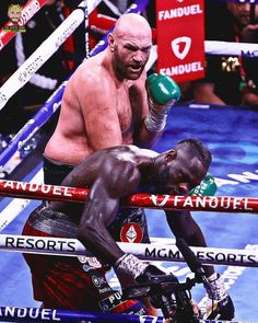 two men in the middle of a boxing ring, one with his head on the ropes