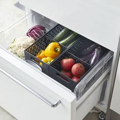 an open refrigerator door with vegetables and fruits in the bottom drawer, including broccoli