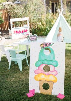 an ice cream themed birthday party is set up in the backyard with pink and green decorations