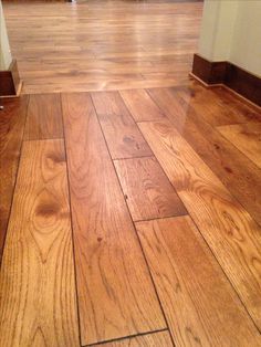 an empty room with wooden floors and hard wood flooring on the ground, looking like it is going to be remodeled