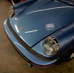 the front end of a blue sports car