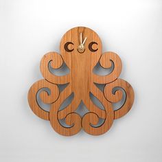 a wooden clock with an octopus on it's face and thought bubble above the clock