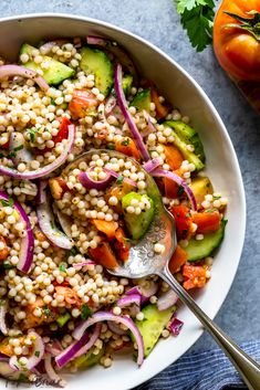 a white bowl filled with couscous and vegetables