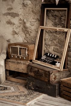 an old wooden box sitting on top of a rug next to a chair and mirror