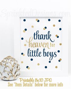 a white frame sitting next to a gold and blue polka dot print with the words, thank heaven for little boys